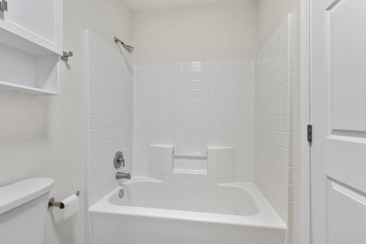 Full bathroom with toilet and shower / tub combination