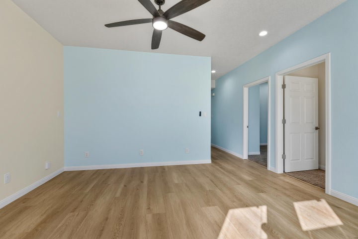 Spare room with light wood-type flooring, ceiling fan, and recessed lighting