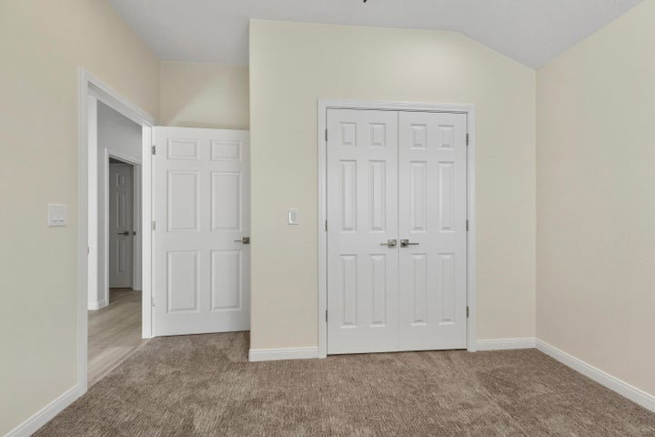 Unfurnished bedroom with carpet floors and a closet