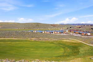 Surrounding community with a mountain view and view of golf course