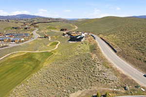 Aerial view of property's location featuring a mountainous background