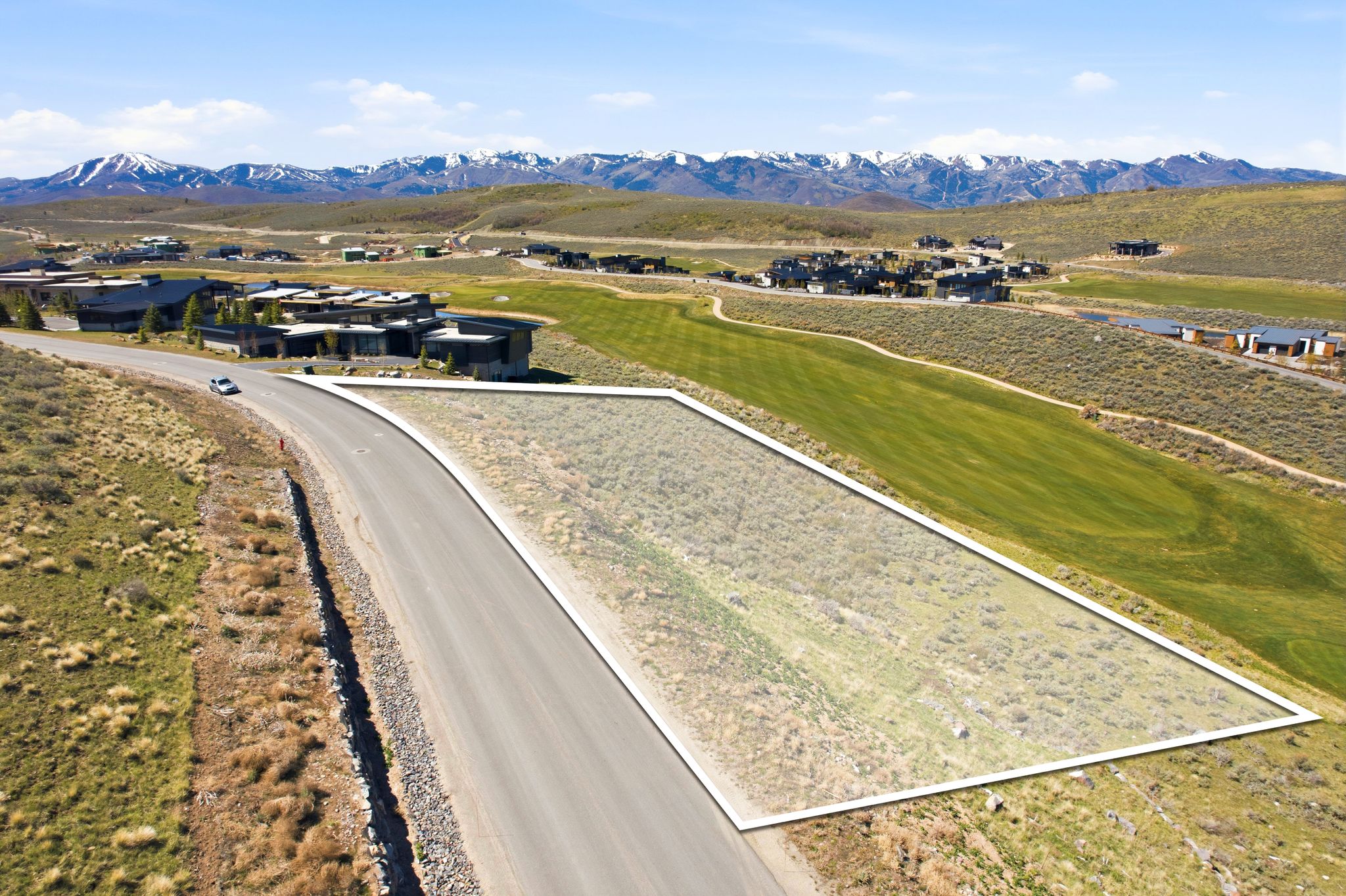 Bird's eye view of a mountainous background and a golf course