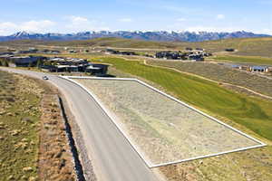 Bird's eye view of a mountainous background and a golf course