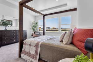 Carpeted bedroom featuring multiple windows