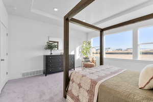Bedroom with light carpet and recessed lighting