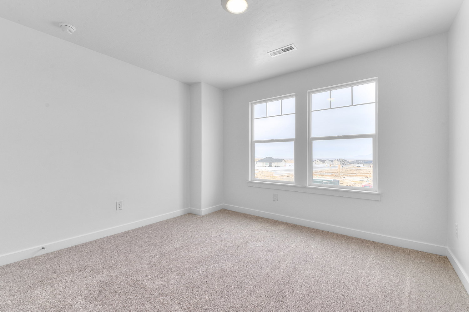 Empty room with baseboards and light carpet