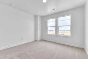 Empty room with baseboards and light carpet