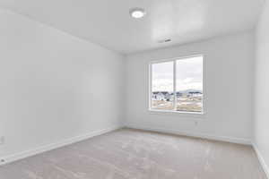 Empty room with light carpet and baseboards