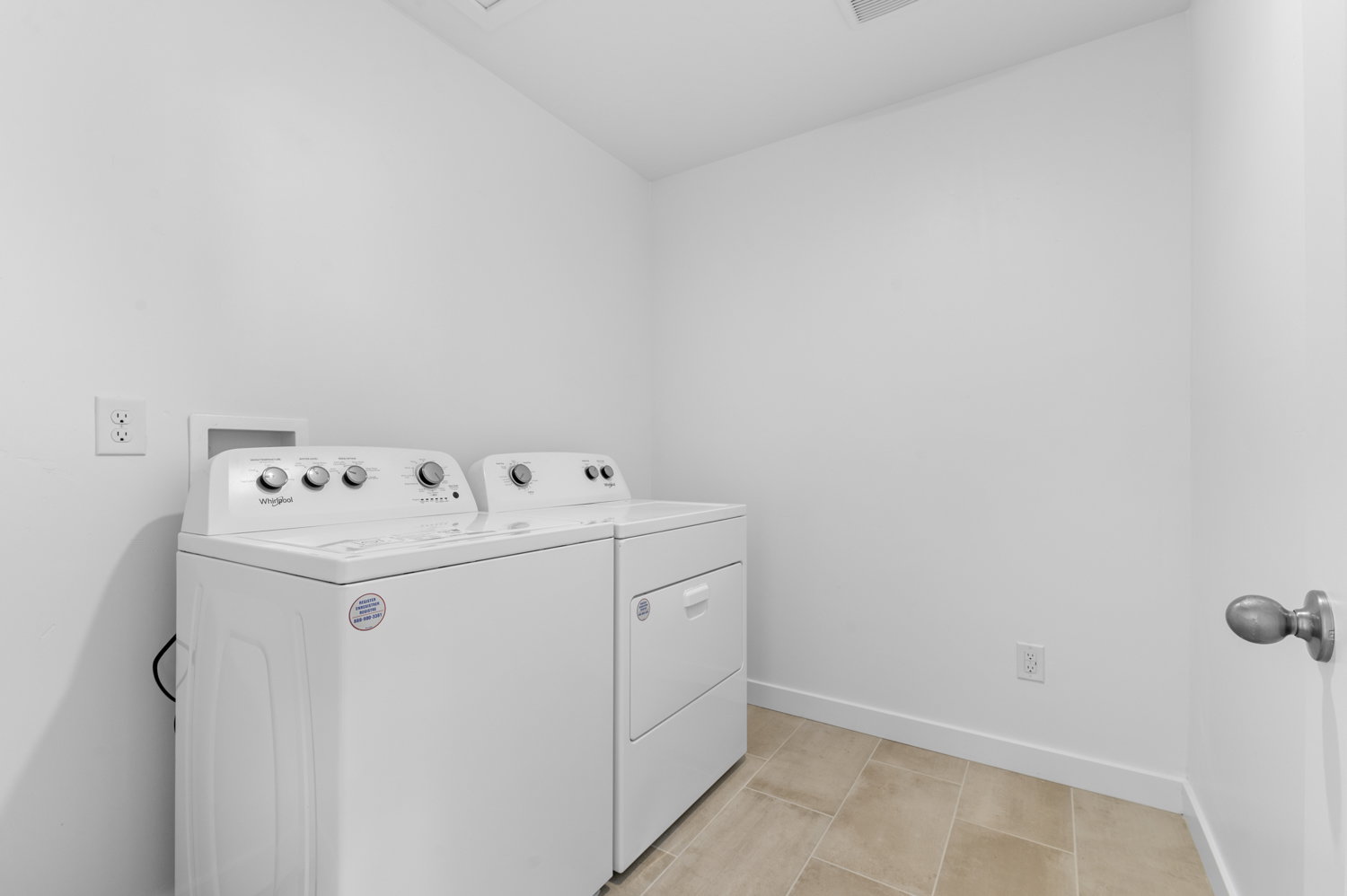 Laundry room featuring separate washer and dryer and vaulted ceiling