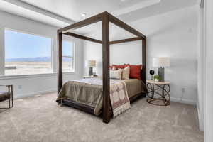 Bedroom featuring light carpet and a mountain view