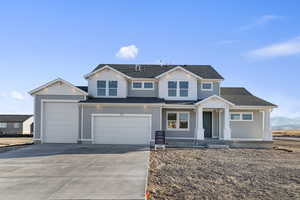 Craftsman-style home with driveway, a shingled roof, covered porch, and an attached garage