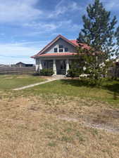 Bungalow-style home with a porch and a tile roof