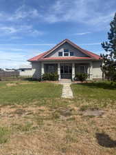 Bungalow-style house with covered porch and a tiled roof
