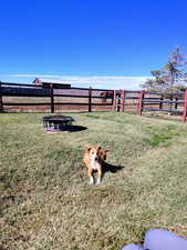 Fenced backyard with a fire pit