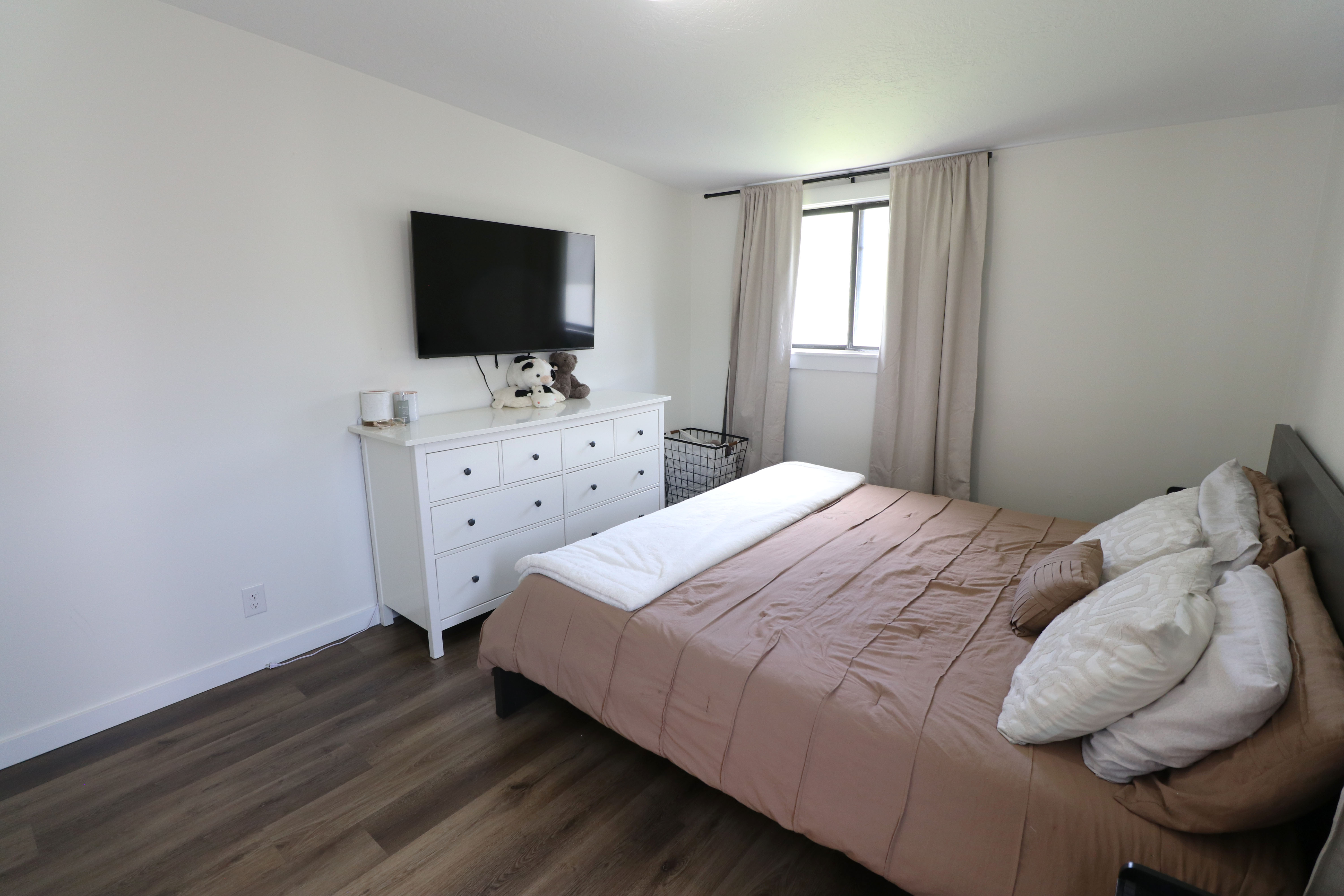 Bedroom featuring baseboards and dark wood-style floors
