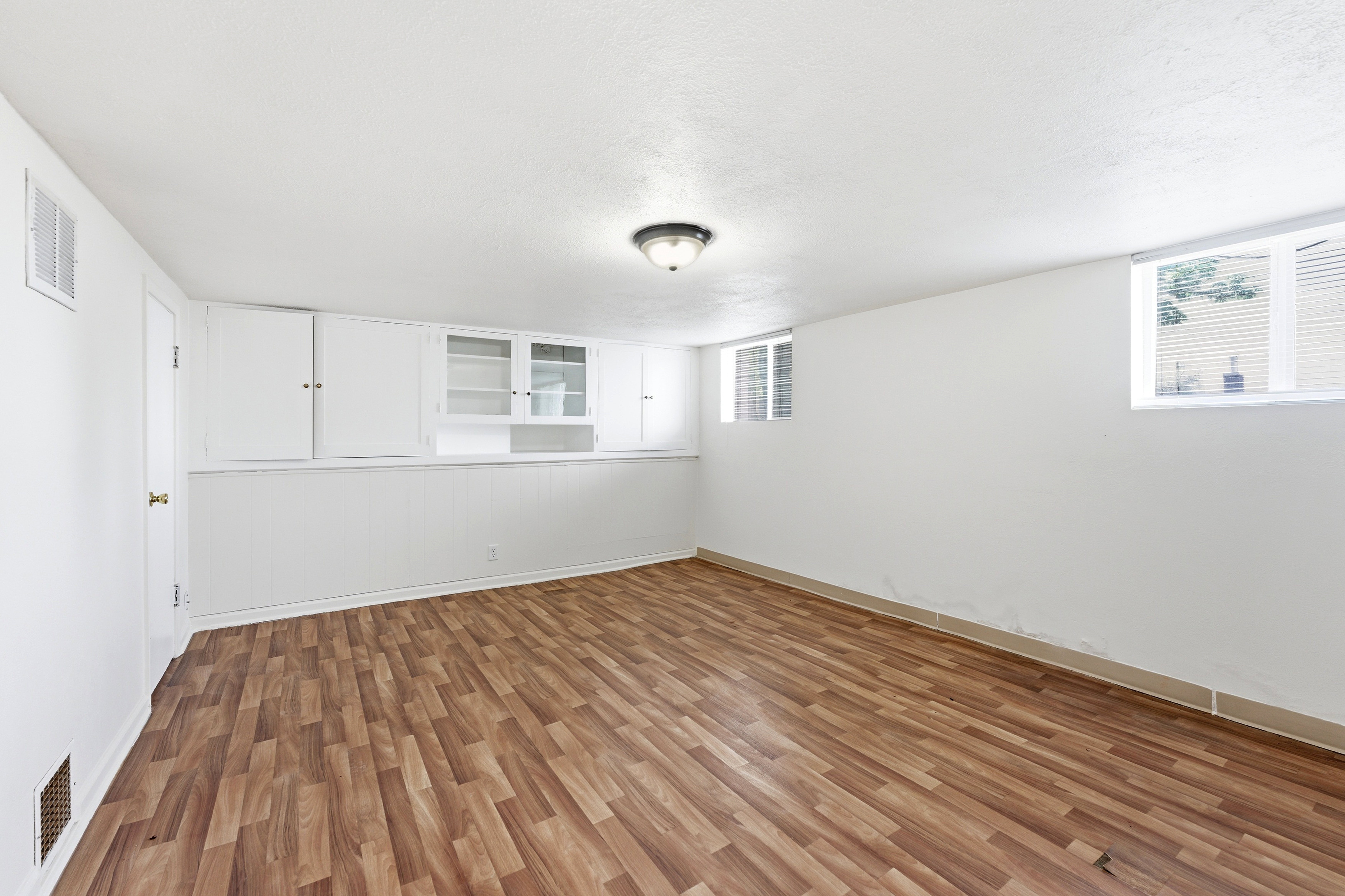 Empty room with light wood finished floors and baseboards