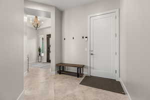 Foyer featuring suspended lighting and baseboards