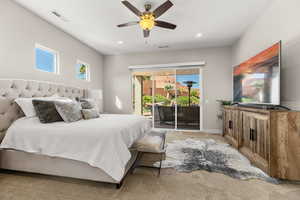 Bedroom featuring access to exterior, a ceiling fan, light carpet, and recessed lighting