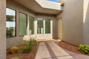 Doorway to property with stucco siding