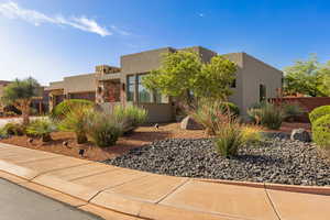 Pueblo-style home featuring stucco siding