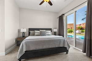 Carpeted bedroom with access to exterior and ceiling fan