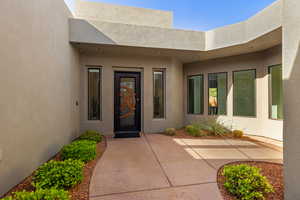 Property entrance with stucco siding
