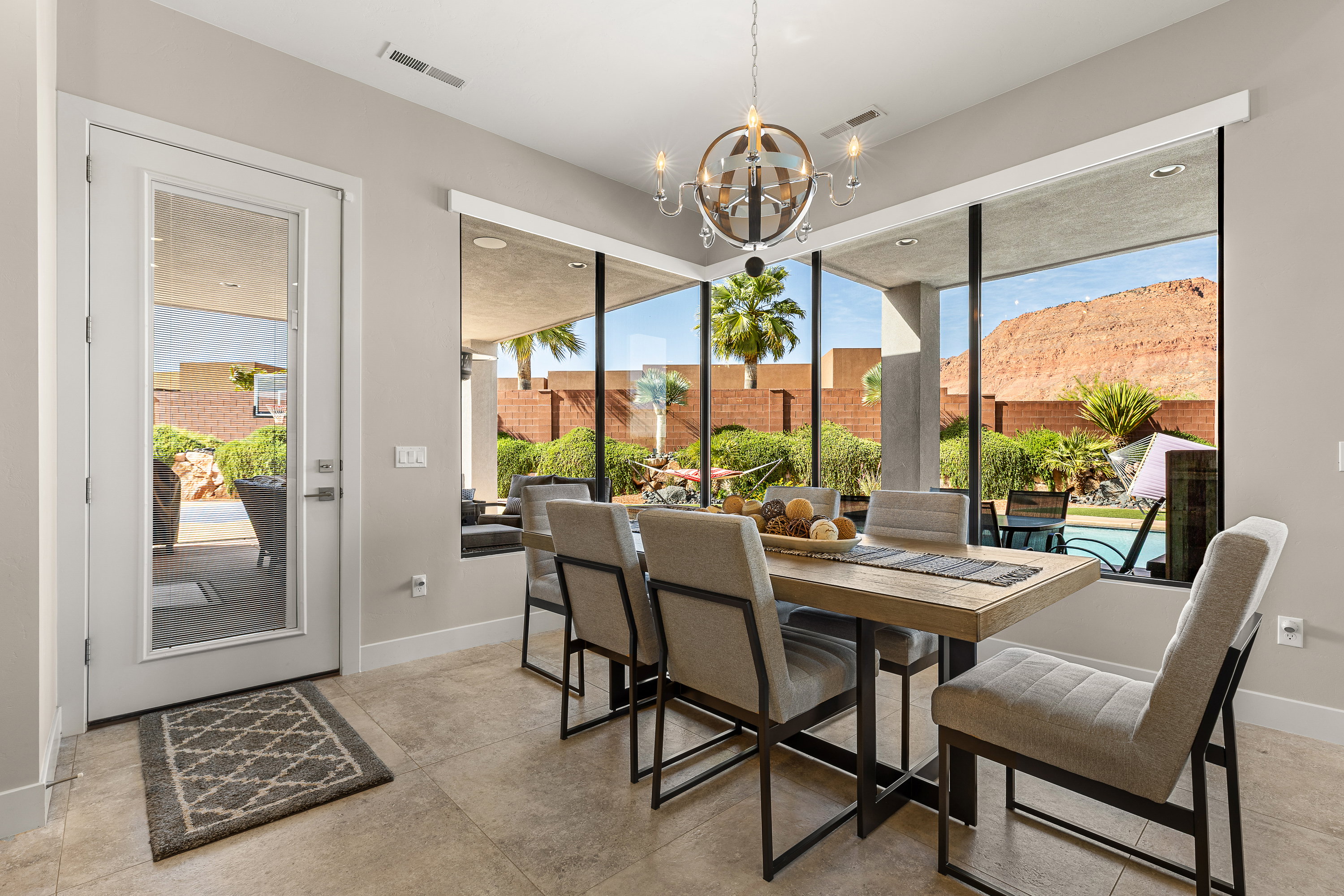 Dining room with suspended lighting and healthy amount of natural light