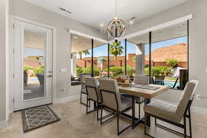 Dining room with suspended lighting and healthy amount of natural light