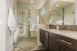 Full bathroom with vanity and a shower stall
