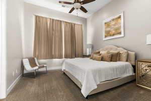 Bedroom featuring dark colored carpet and a ceiling fan
