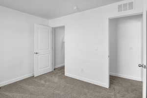 Unfurnished bedroom with baseboards and carpet flooring