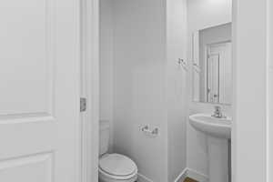 Bathroom with toilet and baseboards