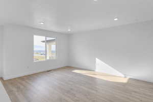 Unfurnished room featuring light wood-style flooring and recessed lighting