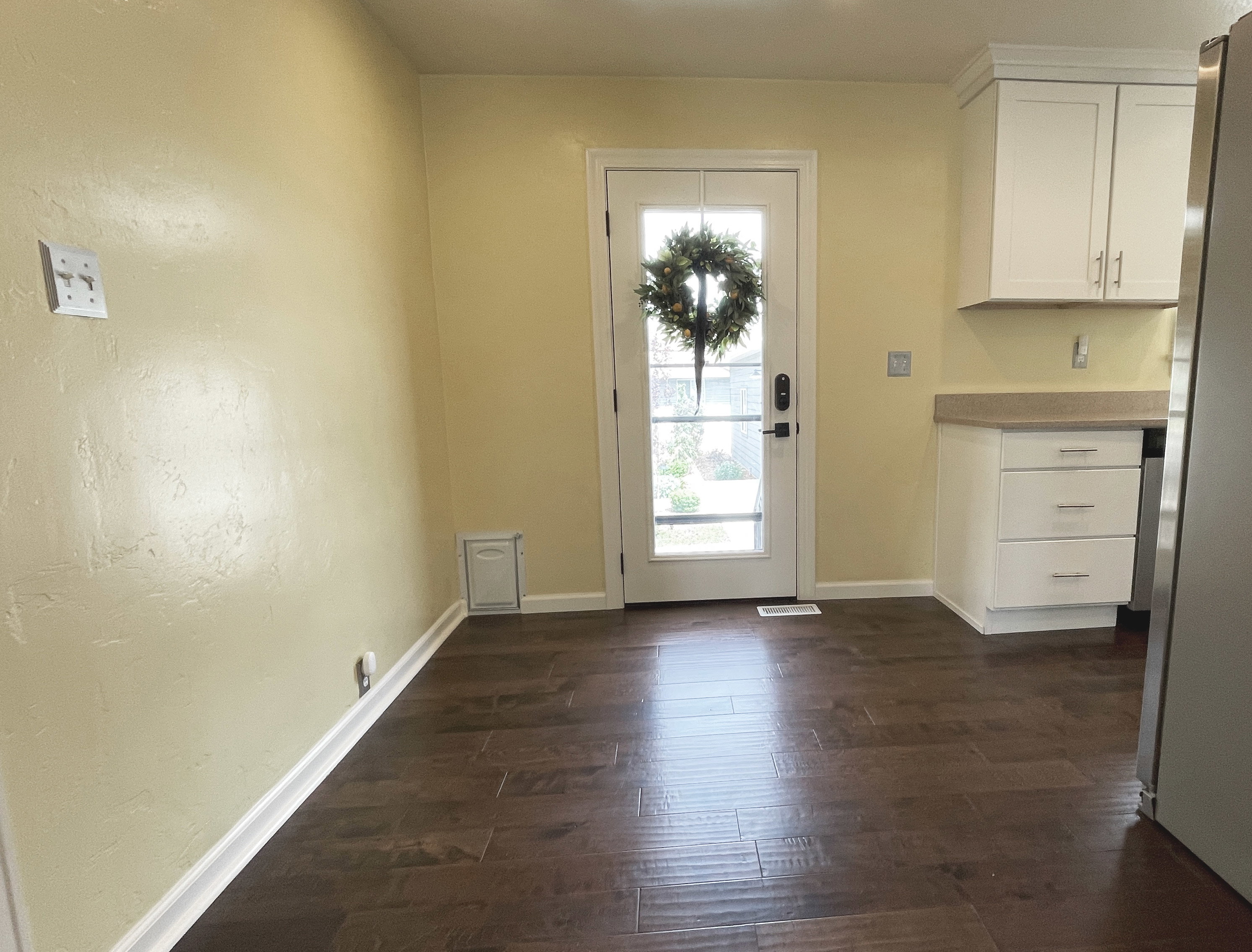 Dark wood-finish flooring complements light-toned walls