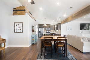 Dining space featuring lofted ceiling, ceiling fan, dark wood-style flooring, and recessed lighting
