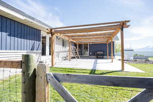 Exterior space featuring a pergola and a gate