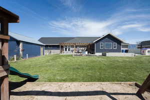 Back of property with a pergola, a patio, and a fenced backyard
