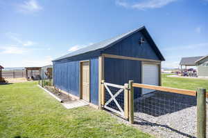 View of outbuilding with a gate