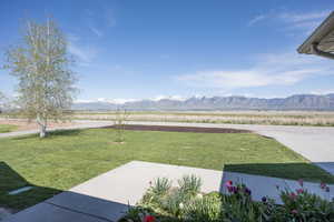 View of green lawn featuring a mountain view