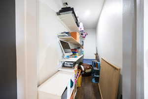 Laundry area with dark wood-type flooring
