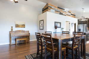 Dining area featuring dark wood finished floors and ceiling fan
