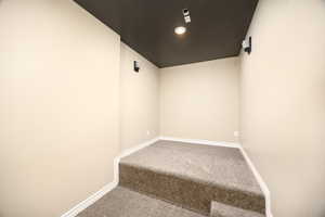 Carpeted spare room featuring baseboards