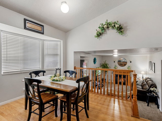 Dining room featuring light wood finished floors and vaulted ceiling