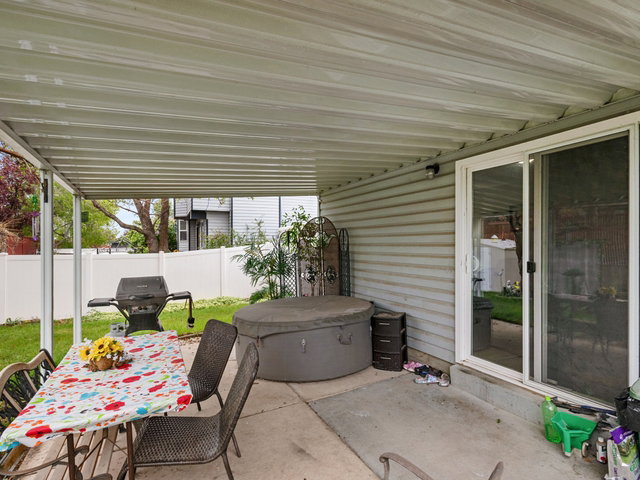 View of patio featuring area for grilling and outdoor dining area