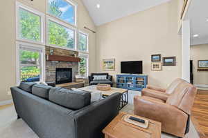 Living area with a fireplace, lofted ceiling, and recessed lighting