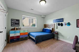 Carpeted bedroom featuring baseboards