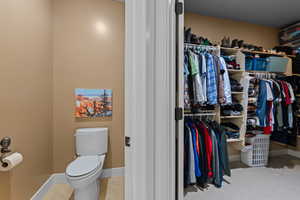 Walk in closet with light tile patterned floors