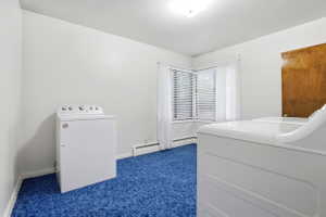 Bedroom with dark colored carpet and washing machine and clothes dryer