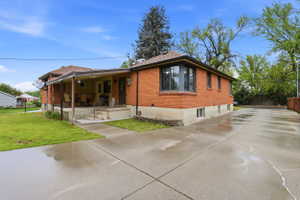 View of front facade with brick siding and concrete driveway