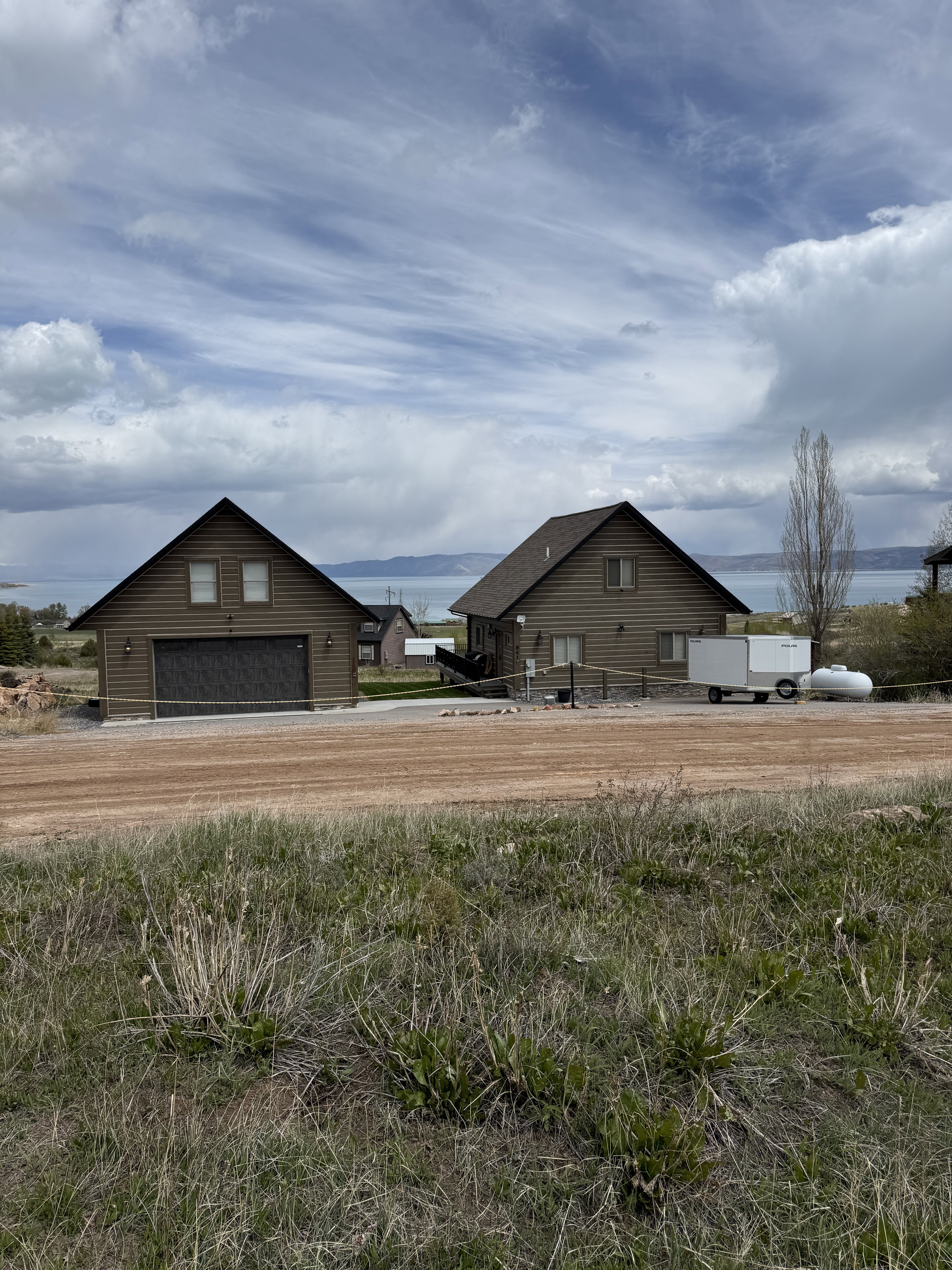Two brown-sided structures under a cloudy sky